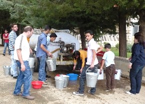 Children getting water in buckets